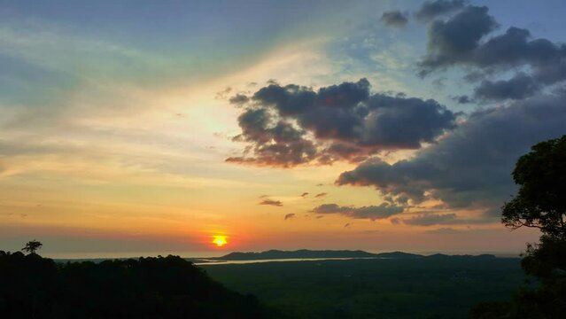 aerial view amazing yellow sky in sunset over the edge of the island..beautiful yellow sunset at the horizon of mountain range in phang Nga Thailand..4k video colorful sky background.