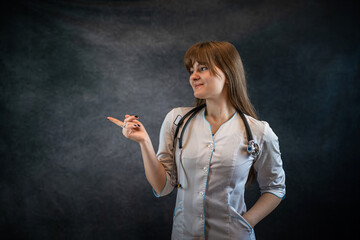 beautiful  doctor in white uniform medical lab coat showing with hand and pointing with finger