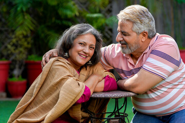 Indian senior couple enjoying and spending time together at out of home.