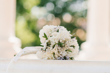 Delicate wedding bouquet with white hydrangea and greenery close-up