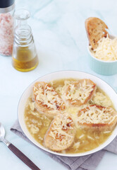 A ceramic bowl with French onion soup