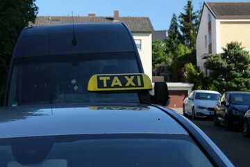 Closeup of taxi logo on a car