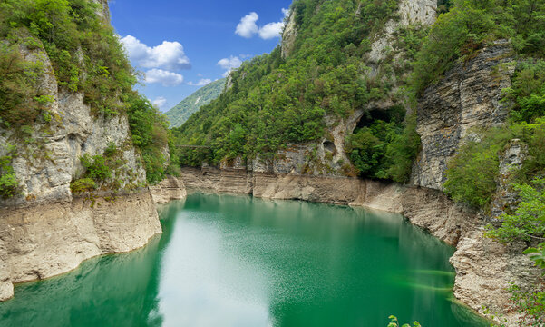 Beautiful landscape of Lake Corlo in Italy surrounded by rocks.