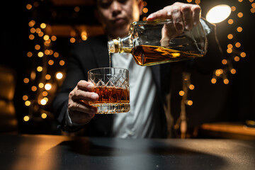 Businessman pouring whiskey victory drink
