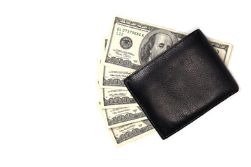 Black leather wallet on a fan of dollars isolated on a white background