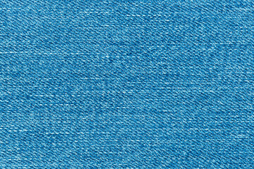 Texture of blue jeans denim background. Canvas blue denim. Top view closeup of grunge blue jeans...