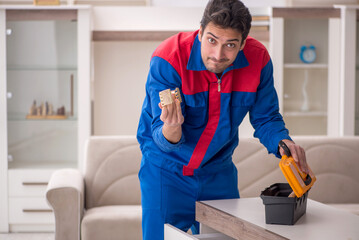 Young male carpenter stealing jewelry at home