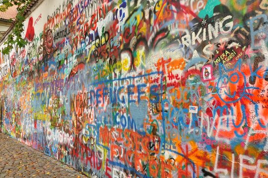 Closeup shot of colorful graffiti on John Lennon Wall in Prague, Czech Republic
