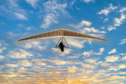 Hang glider flying alone in the sky