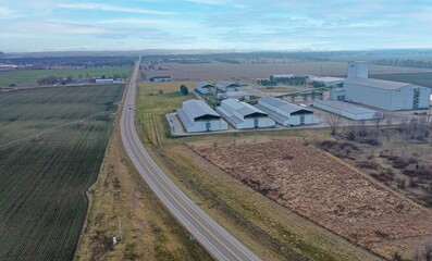 High-angle shot of a row of warehouses next to a field