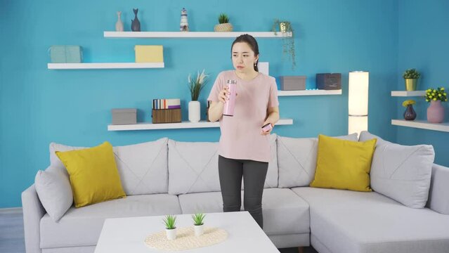 Young asian woman with bad smell feeling sick and disgusted at home.
Young asian woman smelling bad smell in home living room, covering nose, feeling disgusted and nauseous.
