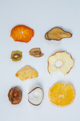 Healthy vegetarian food concept. Assortment of dried fruits, nuts and seeds on white background. Top view. Mixed nuts set closeup.