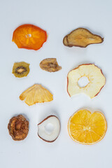 Dried fruits isolated on white background. Healthy eating concept. Top view. Healthy vegetarian food concept. Dried fruit chips.