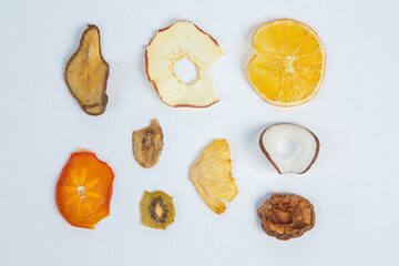 Healthy vegetarian food concept. Assortment of dried fruits, nuts and seeds on white background. Top view. Mixed nuts set closeup.