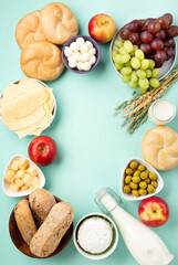 Jewish Shavuot Holiday Card. Dairy Products, Fruits, Cheese, Bread, Milk on Blue Mint Background.