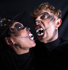 Love couple. Halloween couple. Shadow. Dark background. 