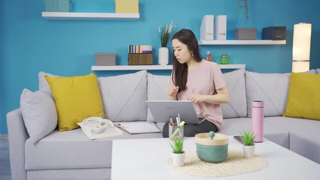 Asian young woman finds her lost property at home.
Asian young woman looking and finding her lost or forgotten item.
