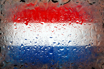 Netherlands flag. Netherlands flag on the background of water drops. Flag with raindrops. Splashes on glass