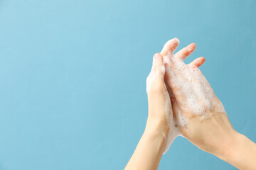 Hands with foam, spa, beauty procedures and skin care concept