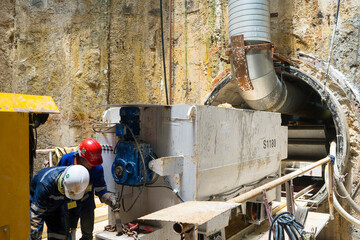 Technician control underground tunnel construction at working shaft to Material transport train for...
