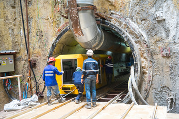Technician control underground tunnel construction at working shaft to Material transport train for...
