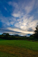 Vertical shot of a bright blue sunset sky over a rural field in NSW, Australia