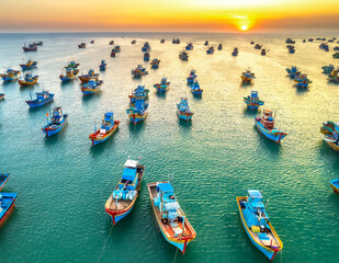 Fototapeta na wymiar Aerial view of Mui Ne fishing village in sunset sky with hundreds of boats anchored to avoid storms, this is a beautiful bay in central Vietnam
