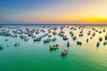 Aerial view of Mui Ne fishing village in sunset sky with hundreds of boats anchored to avoid storms, this is a beautiful bay in central Vietnam