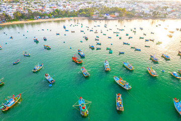 Fototapeta na wymiar Aerial view of Mui Ne fishing village in the morning with hundreds of boats anchored to avoid storms, this is a beautiful bay in central Vietnam