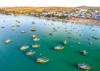 Fototapeta na wymiar Aerial view of Mui Ne fishing village in the morning with hundreds of boats anchored to avoid storms, this is a beautiful bay in central Vietnam