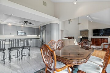 Set of brown table and chairs with the grey kitchen in the background