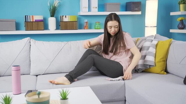 Asian young woman wearing socks is leaving the house.
Prepared young asian woman puts on her stockings and leaves the house.
