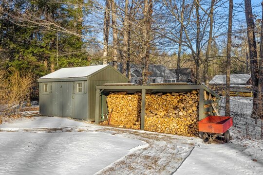 Closeup of a woodshed surrounded with snow