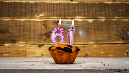 Muffin with candle burning background for anniversary. Greeting card for the holiday. Happy...