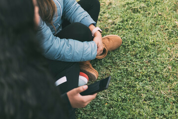 Hispanic friends bonding over technology in the park