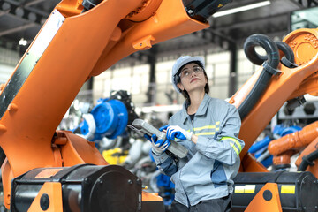 Female industrial engineer maintenance mechanic orange robot frame then assembly to robotic...
