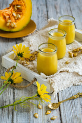 pumpkin pudding in glass bottles on atray