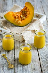 pumpkin pudding in glass bottles on atray