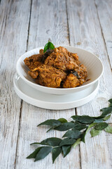 rendang ayam or chicken rendang in white ceramic bowl
