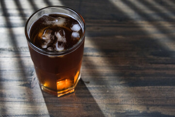 A glass of tea with harsh light