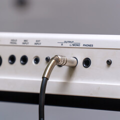 Audio jacks are plugged into a guitar synthesizer or processor