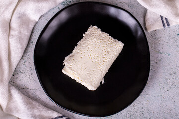 Clotted cream on gray background. Clotted cream (butter cream) for Turkish breakfast. local name inek kaymak. Top view