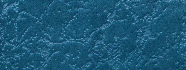 Texture of dark turquoise velvet background from a soft upholstery textile material. Abstract blue velour fabric