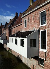 Fototapeta na wymiar The famous hanging kitchens over the Damsterdiep canal in Appingedam in Groningen, the Netherlands 