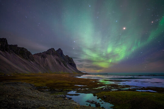 Aerial view of northern lights at Stokksnes bay near the Vestrahorn mountain, Austurland, Iceland.