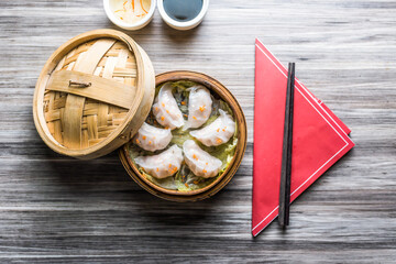 Prawn Hargao with sauce and chopsticks isolated on wooden board top view on table fastfood