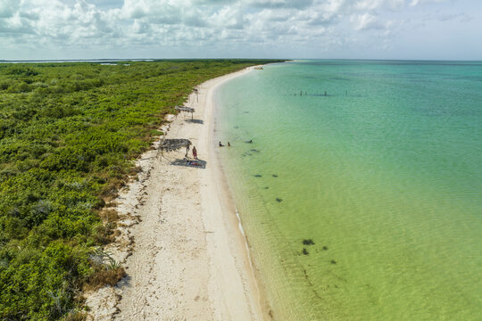 Aerial view of people on the beach at Punta Escolleras coastline, Rio Lagartos natural park, Yucatan, Mexico.