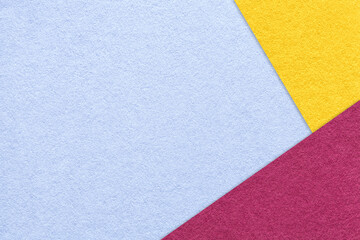 Fototapeta premium Texture of craft light blue color paper background with yellow and purple border. Vintage abstract cardboard.