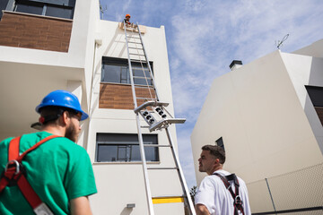 Technician pulling equipment with rope