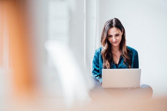 Businesswoman working on laptop at home office